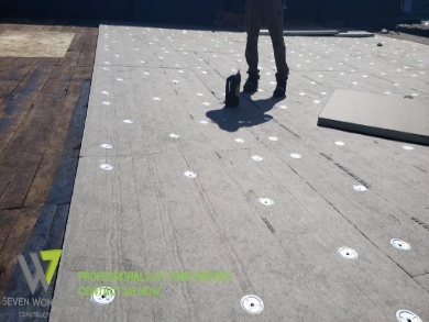 A man stands on a roof in New Jersey, with a large white dot above him, showcasing a 3D roofing design animation.